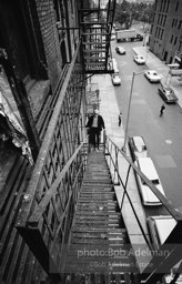 Andy Warhol on the Factory fire escape ouside of the Factory overlooking East 47th St. New York City, 1965.