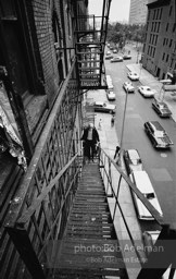 Andy Warhol on the Factory fire escape ouside of the Factory overlooking East 47th St. New York City, 1965.