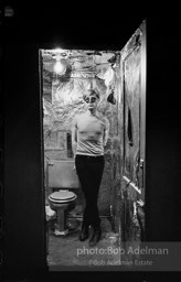 Andy Warhol in the silver foil covered bathroom at the Factory, 1965.