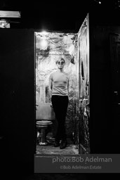 Andy Warhol in the silver foil covered bathroom at the Factory, 1965.