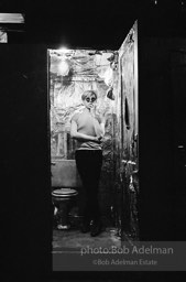 Andy Warhol in the silver foil covered bathroom at the Factory, 1965.