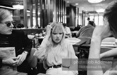 Andy Warhol, Bibbe Hanson and Chuck Wein at a mid-town restaurant. New York City, 1965.