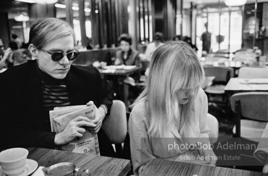 Andy Warhol and Bibbe Hanson at a mid-town restaurant, New York City, 1965.