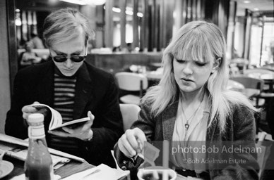 Andy Warhol and Bibbe Hanson at a mid-town restaurant, New York City, 1965.