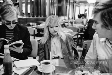 Andy Warhol, Bibbe Hanson and Chuck Wein at a mid-town restaurant. New York City, 1965.