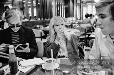 Andy Warhol, Bibbe Hanson and Chuck Wein at a mid-town restaurant. New York City, 1965.