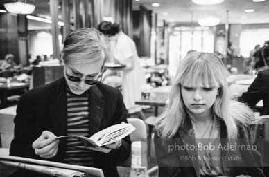 Andy Warhol and Bibbe Hanson at a mid-town restaurant, New York City, 1965.