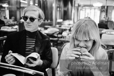 Andy Warhol and Bibbe Hanson at a mid-town restaurant, New York City, 1965.