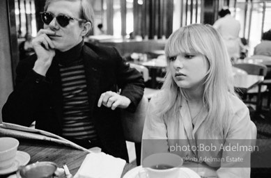 Andy Warhol and Bibbe Hanson at a mid-town restaurant, New York City, 1965.