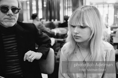 Andy Warhol and Bibbe Hanson at a mid-town restaurant, New York City, 1965.