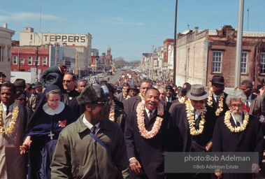 Crossing over: King leads the Montgomery-bound marchers over the Edmund Pettus Bridge, which was already famous for shocking scenes of police brutality,   Selma,  Alabama.  1965